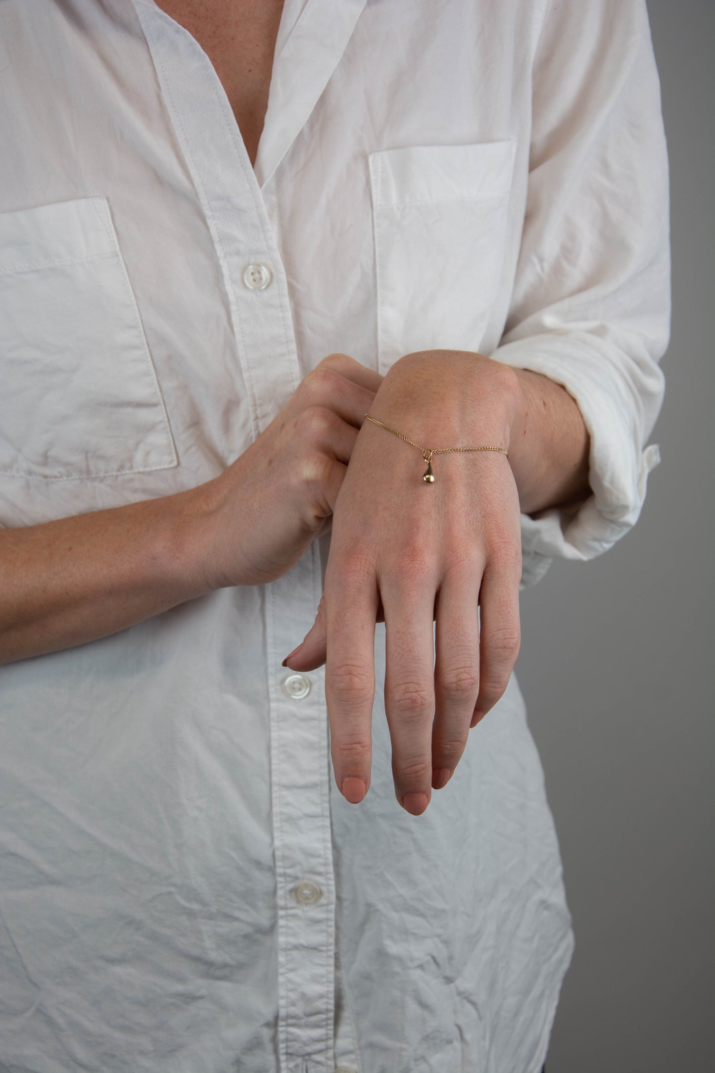 Solid 14k gold curbed chain teardrop charm bracelet handmade in Asheville, NC.