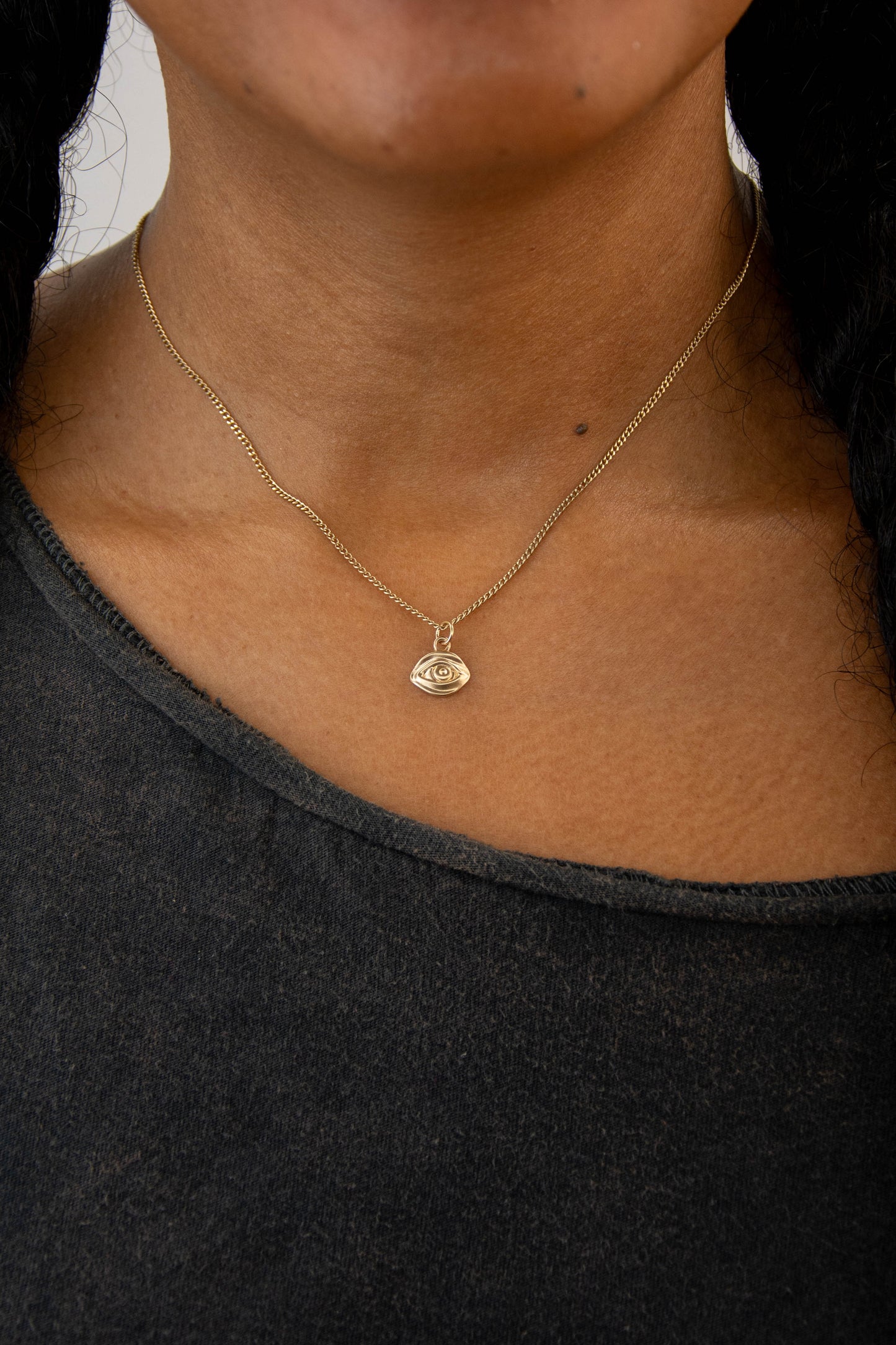 Solid 14k eye charm necklace handmade in Asheville, NC.