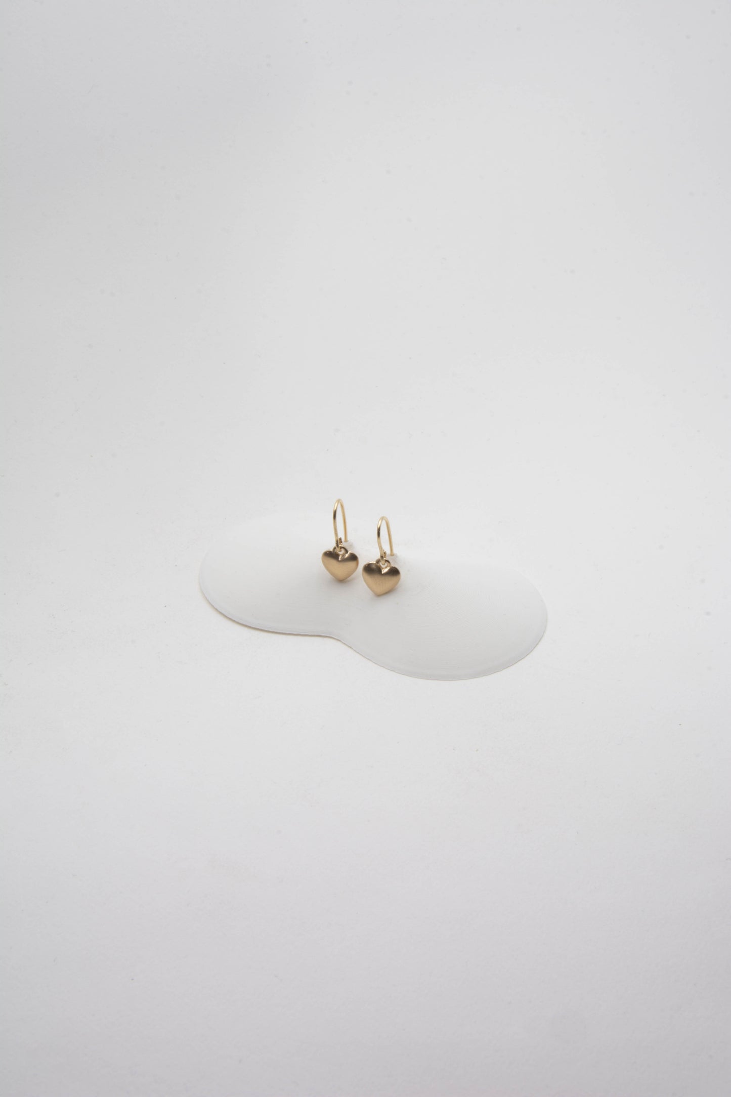 Solid 14k gold heart charm earrings handmade in Asheville, NC.