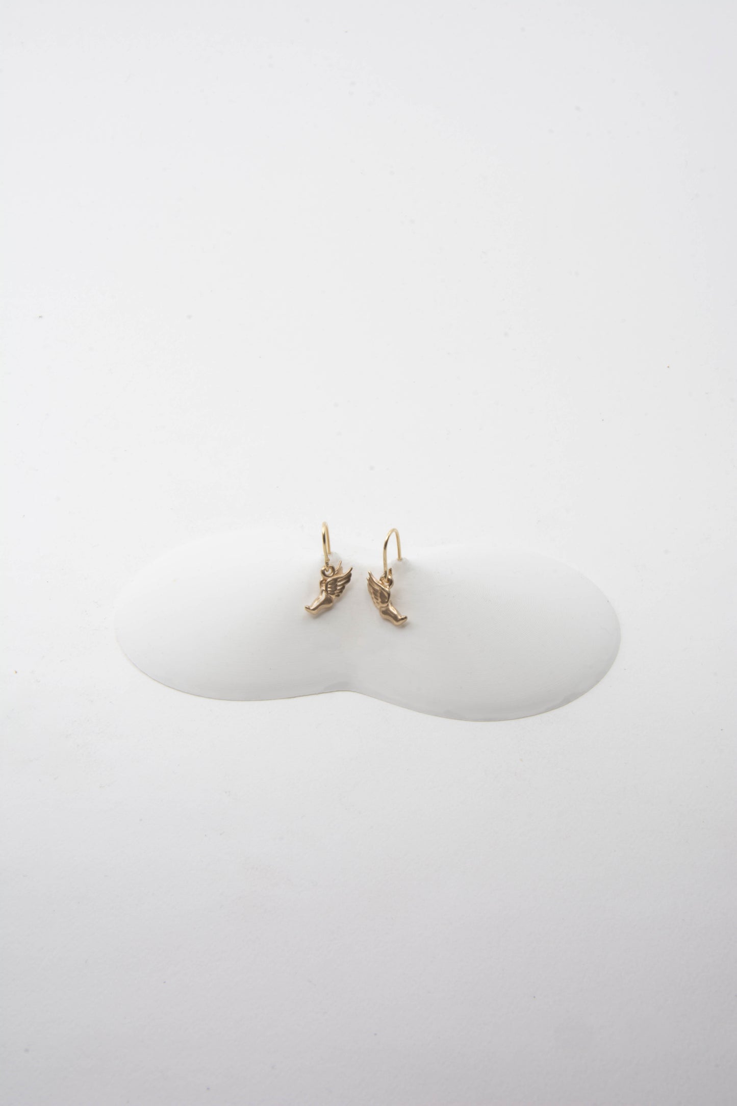 Solid 14k gold Hermes running foot charm earrings handmade in Asheville, NC.