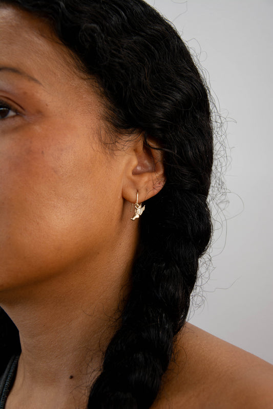 Solid 14k Hermes running foot earrings handmade in Asheville, NC.