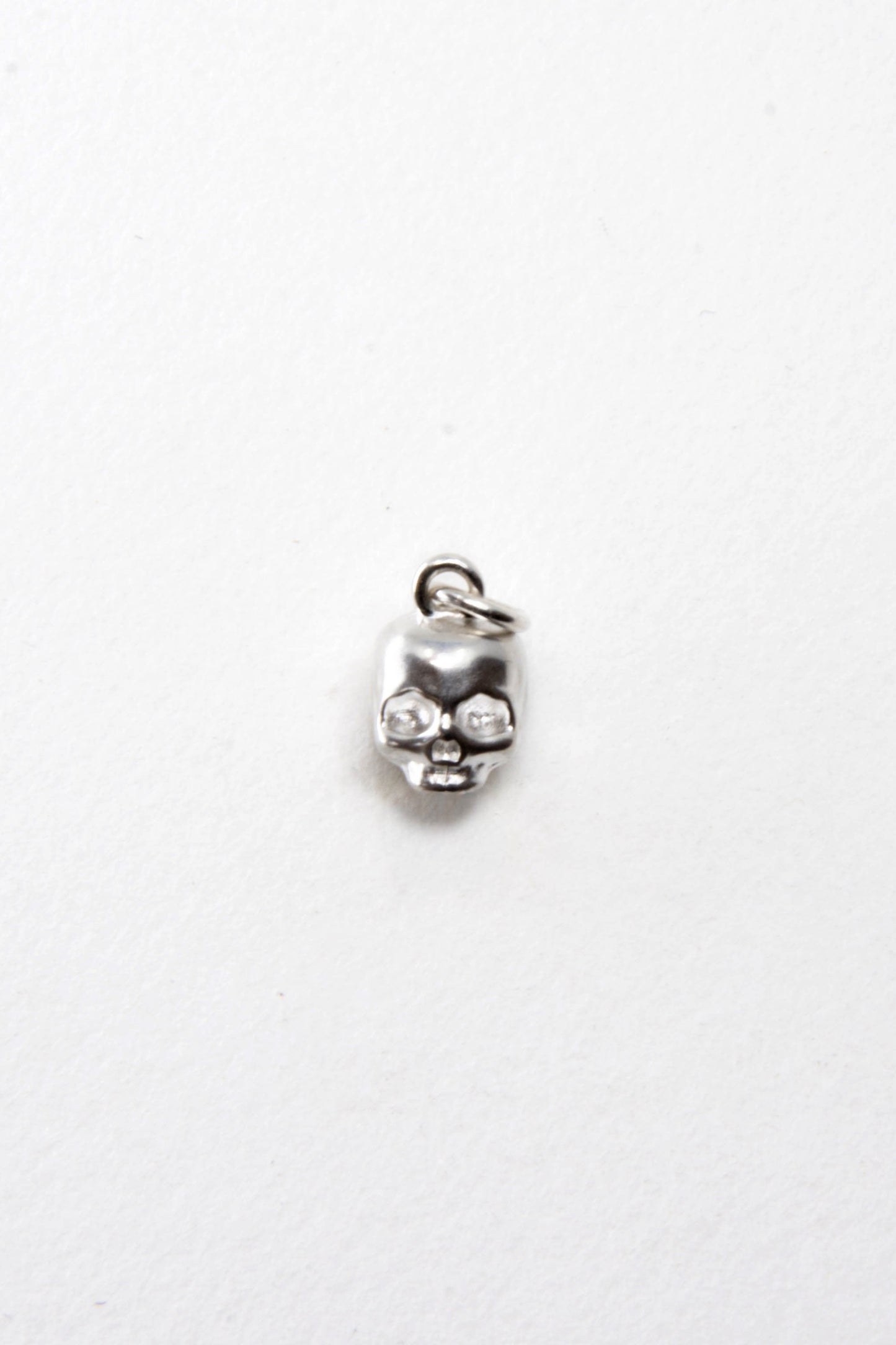 Solid sterling silver 925 skull charm handmade in Asheville NC.