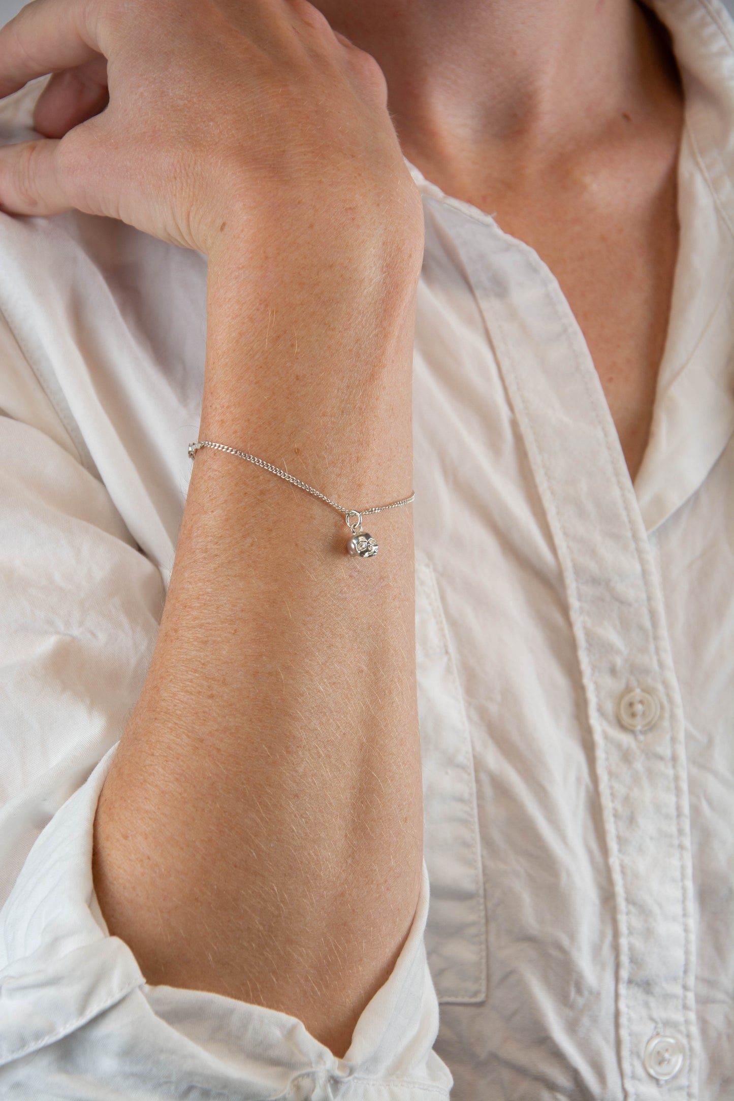 Solid sterling silver 925 curbed chain skull charm bracelet handmade in Asheville, NC.