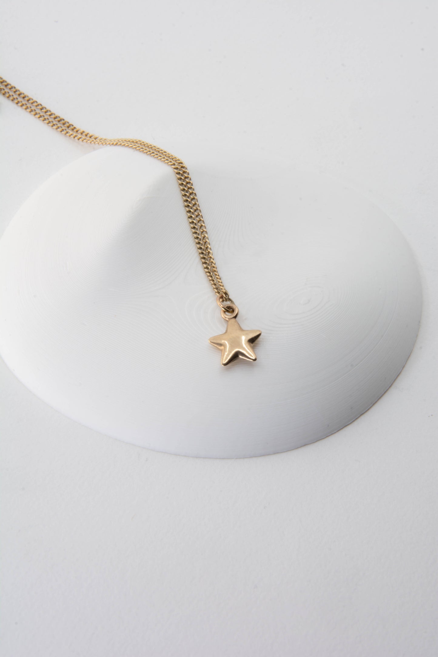 Solid 14k star charm necklace handmade in Asheville, NC.