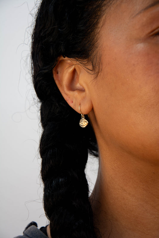 Solid 14k gold eye charm earrings handmade in Asheville, NC. 