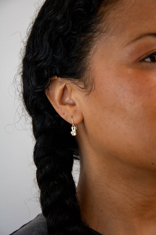Solid 14k gold peace sign charm earrings handmade in Asheville, NC. 