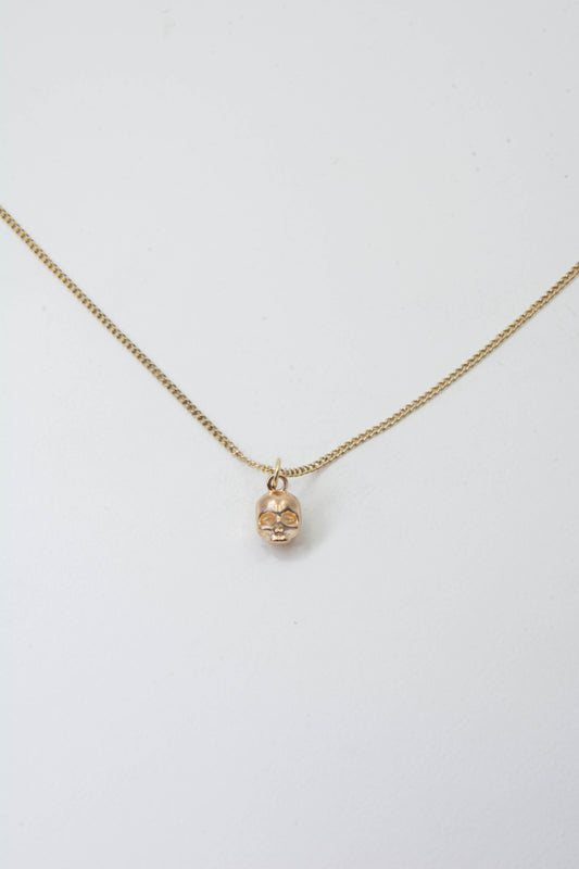Solid 14k skull charm necklace handmade in Asheville, NC.